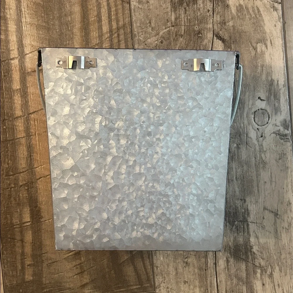 Galvanized silver toilet paper holder. Can hang on wall or free standing.